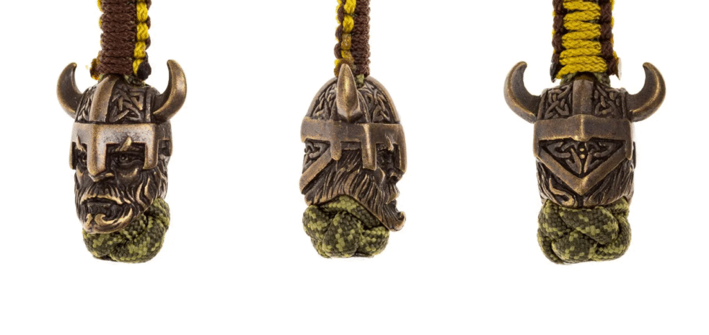 Detailed Viking warrior head charm made of brass, woven into a lanyard, perfect example of paracord beads with Nordic knotwork design.