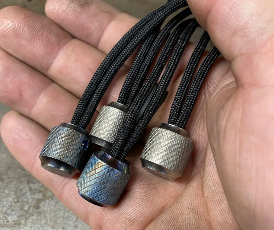 Titanium paracord beads on a paracord bracelet for outdoor use.