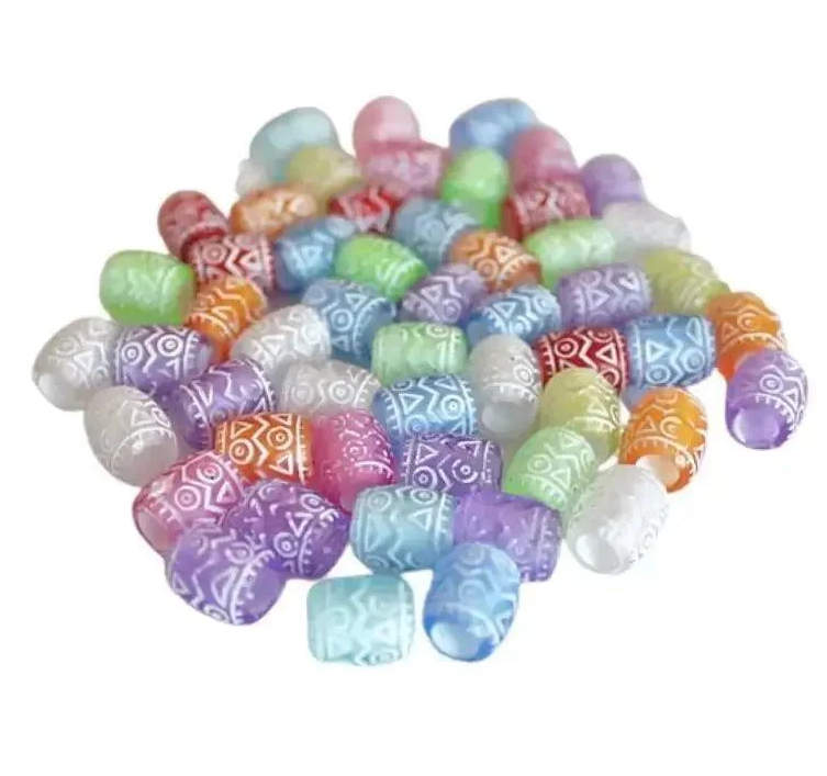 Assortment of acrylic paracord beads showing different colors, shapes including skulls, spheres, and barrels with visible bore holes for 550 paracord threading
