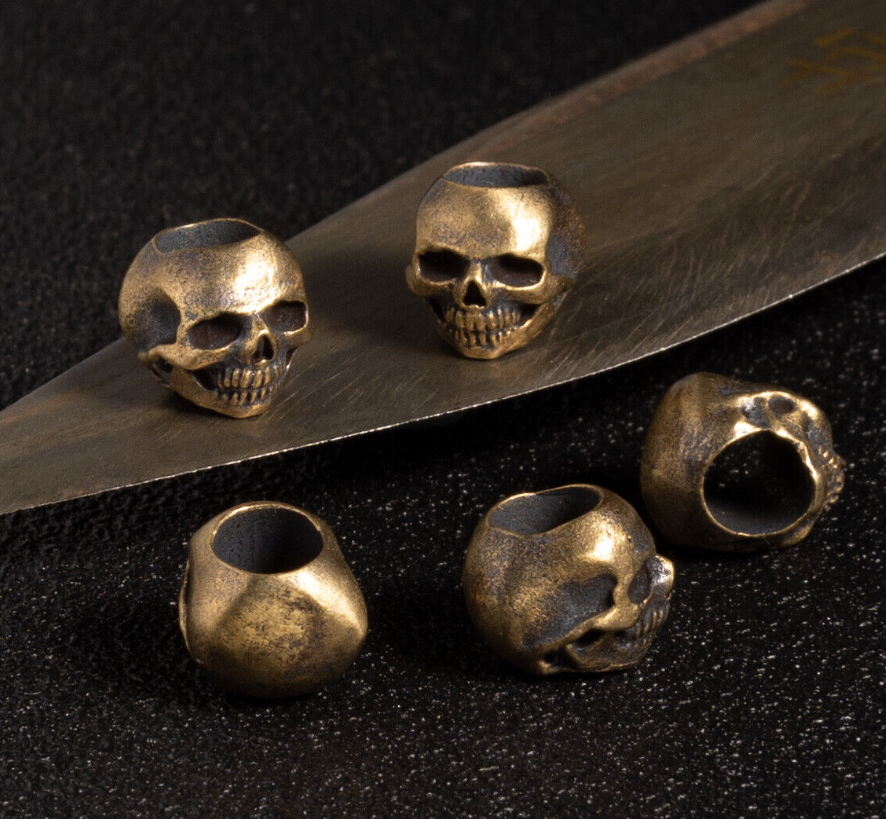 Skull paracord beads ranging from 8mm to 25mm displayed with ruler showing size scale for different projects