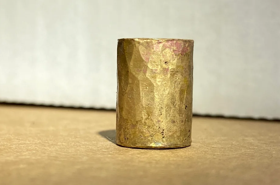 Workshop setup for patinating brass beads showing chemical solutions, safety equipment, and brass beads in various oxidation stages