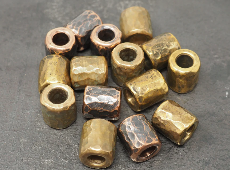 Brass paracord beads comparison showing cylinder, skull, and tritium holder styles for 550 cord