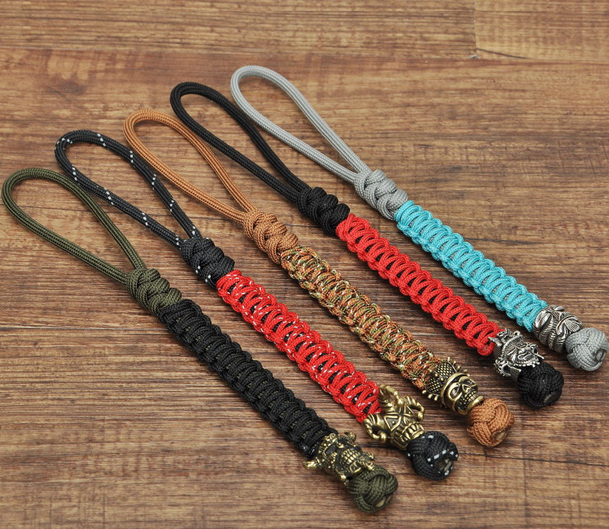 Skull brass bead attached to tactical knife lanyard with 550 paracord cobra weave