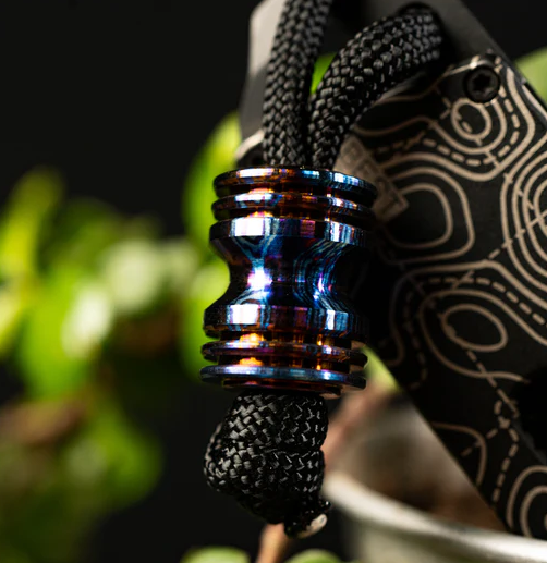 Diamond knot securing timascus bead on custom knife lanyard with proper spacing technique