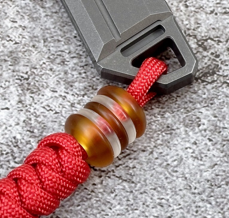 Paracord lanyard featuring decorative acrylic skull beads as focal points with stopper knots demonstrating bead integration techniques for accessories
