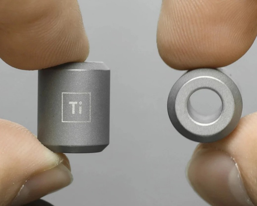 Titanium bead mounted on wooden dowel for hands-free polishing showing proper holding technique